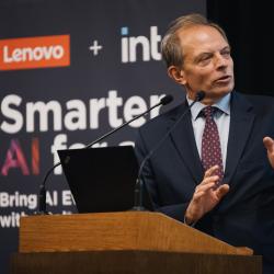 Person behind a podium, giving a presentation