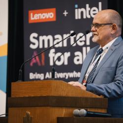 Person behind a podium, giving a presentation