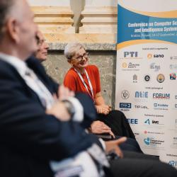 People in an auditorium, listening to a presentation
