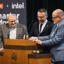 People behind a podium, giving a presentation
