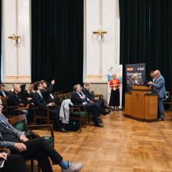 People in an auditorium, listening to a presentation