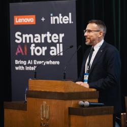 Person behind a podium, giving a presentation