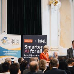 People in an auditorium, listening to a presentation
