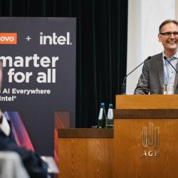 Person behind a podium, giving a presentation
