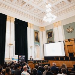 People in an auditorium, listening to a presentation