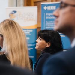 People in an auditorium, listening to a presentation
