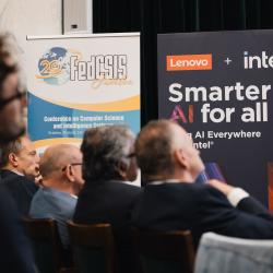 People in an auditorium, listening to a presentation