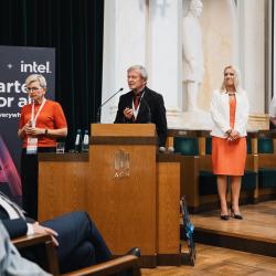 People behind a podium, giving a presentation