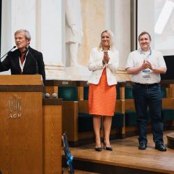 People behind a podium, giving a presentation