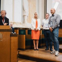 People behind a podium, giving a presentation