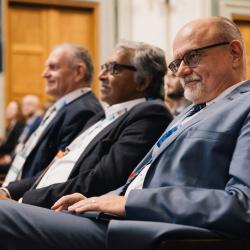People listening to a presentation, in an auditorium