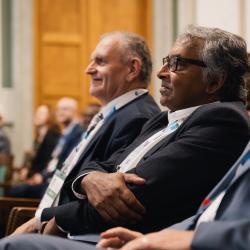 People listening to a presentation, in an auditorium