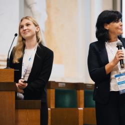 People giving a presentation in an auditorium
