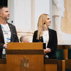 People behind a podium, giving a presentation