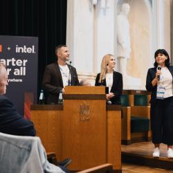 People behind a podium, giving a presentation