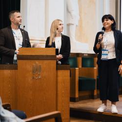 People behind a podium, giving a presentation