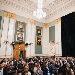 People in an auditorium, listening to a presentation