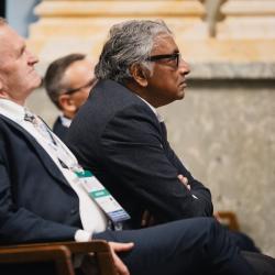People in an auditorium, listening to a presentation