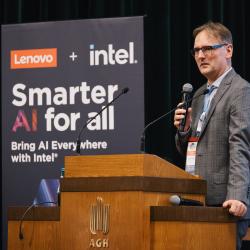 Person behind a podium, giving a presentation