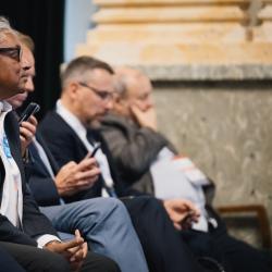 People in an auditorium, listening to a presentation