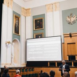 People in an auditorium, listening to a presentation