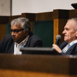 People behind a podium, talking