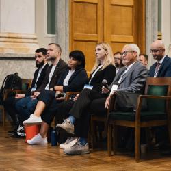 People in an auditorium, listening to a presentation