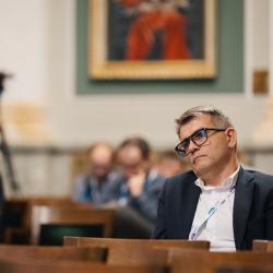 People in an auditorium, listening to a presentation