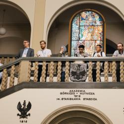 People in a building hall, looking down from the second floor