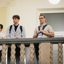 People in a building hall, looking down from the second floor