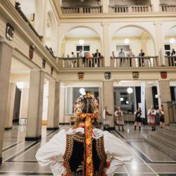 People in a building hall, looking down from the second floor