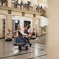 Dancers in a building hall, people listening from the second floor