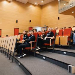 Person giving to a presentation in an auditorium