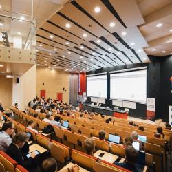 People listening to a presentation in an auditorium