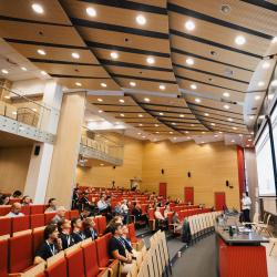 People listening to a presentation in an auditorium
