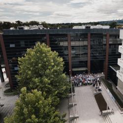 Crowd of people, posing for a foto in front of a building