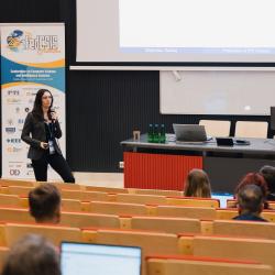 Person giving to a presentation in an auditorium