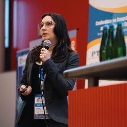 Person giving to a presentation in an auditorium