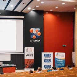 Person giving to a presentation in an auditorium