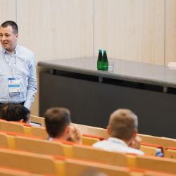 Person giving to a presentation in an auditorium