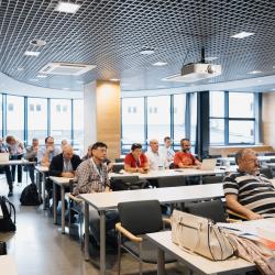 Lecture room with people listening to a presentation