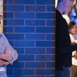 Person standing next to a wall