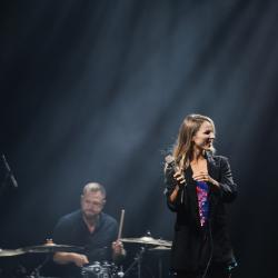 Music band on a dark stage, lit up by stage lights