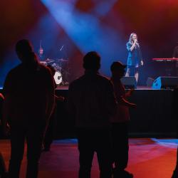 Music band on a dark stage, lit up by stage lights