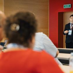 Person giving a presentation in a lecture room