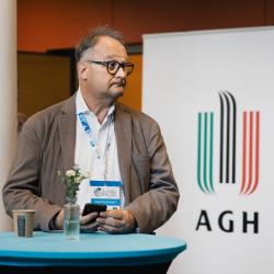 Person standing behind a table