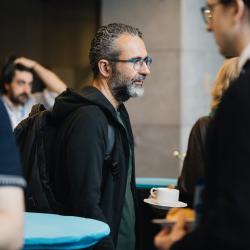 Person carrying a coffe cup