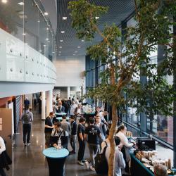 People gathered in a hall with tables