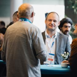 People standing around a table, talking