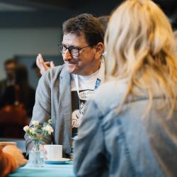 People standing around a table, talking